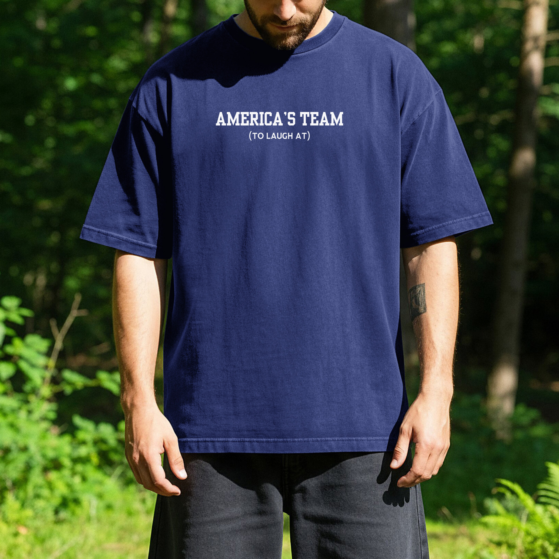 person standing outdoors wearing a blue t-shirt with white text that reads Americas Team (tolaugh at)
