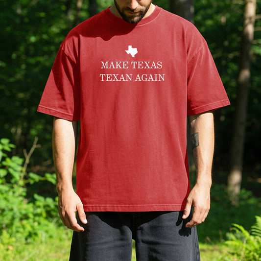 person standing outdoors wearing a red t-shirt with white text that reads, Make Texas Texan Again, with a small outline of the state of Texas above the text